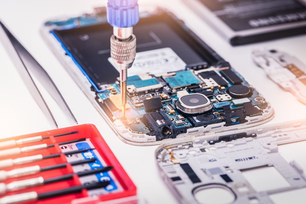 technician working on a phones internal compnents