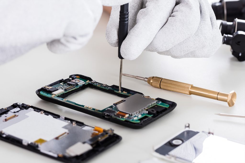 technician repairing a cell phone