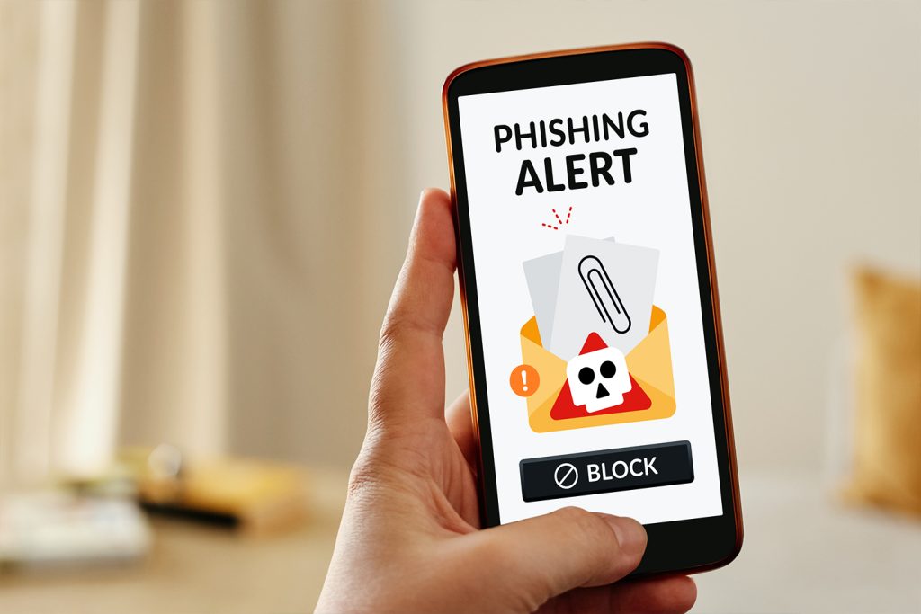 smartphone with a phiosing alert graphic on their phone