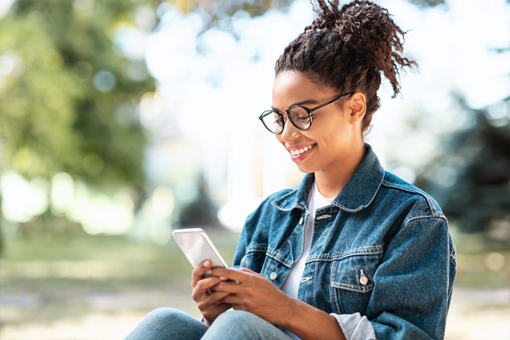 woman looking at her smartphone in the park