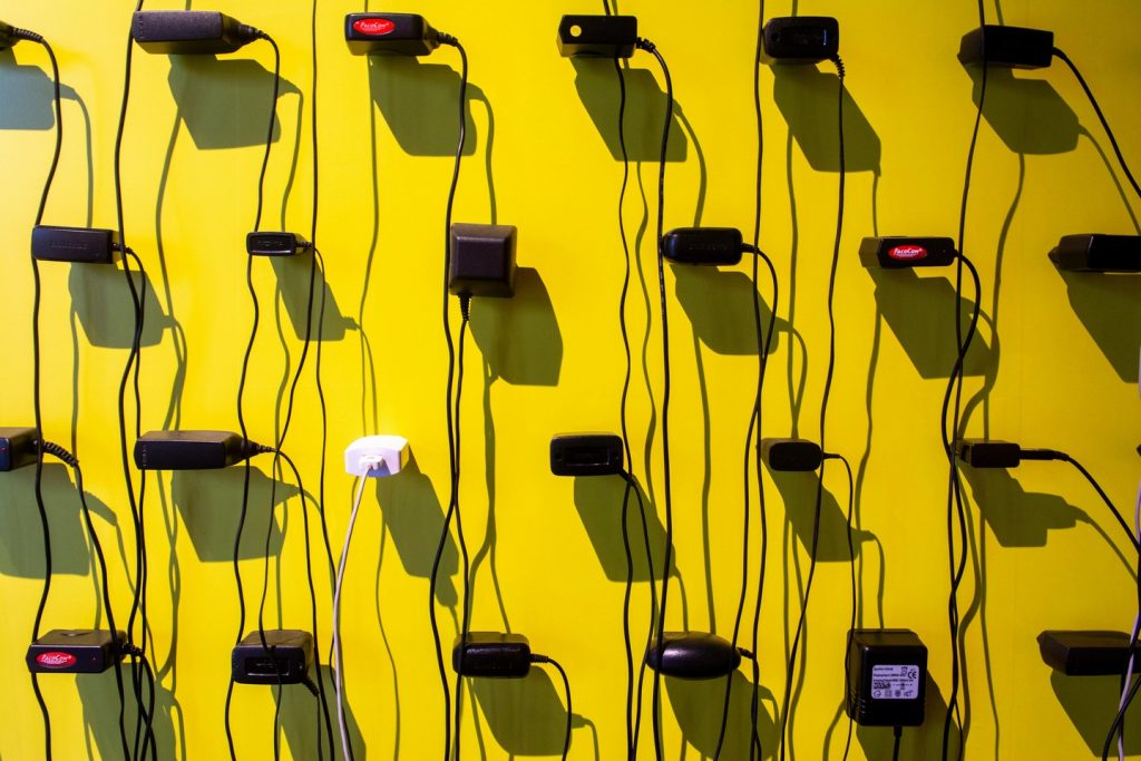 wall of various charges with a yellow backgorund