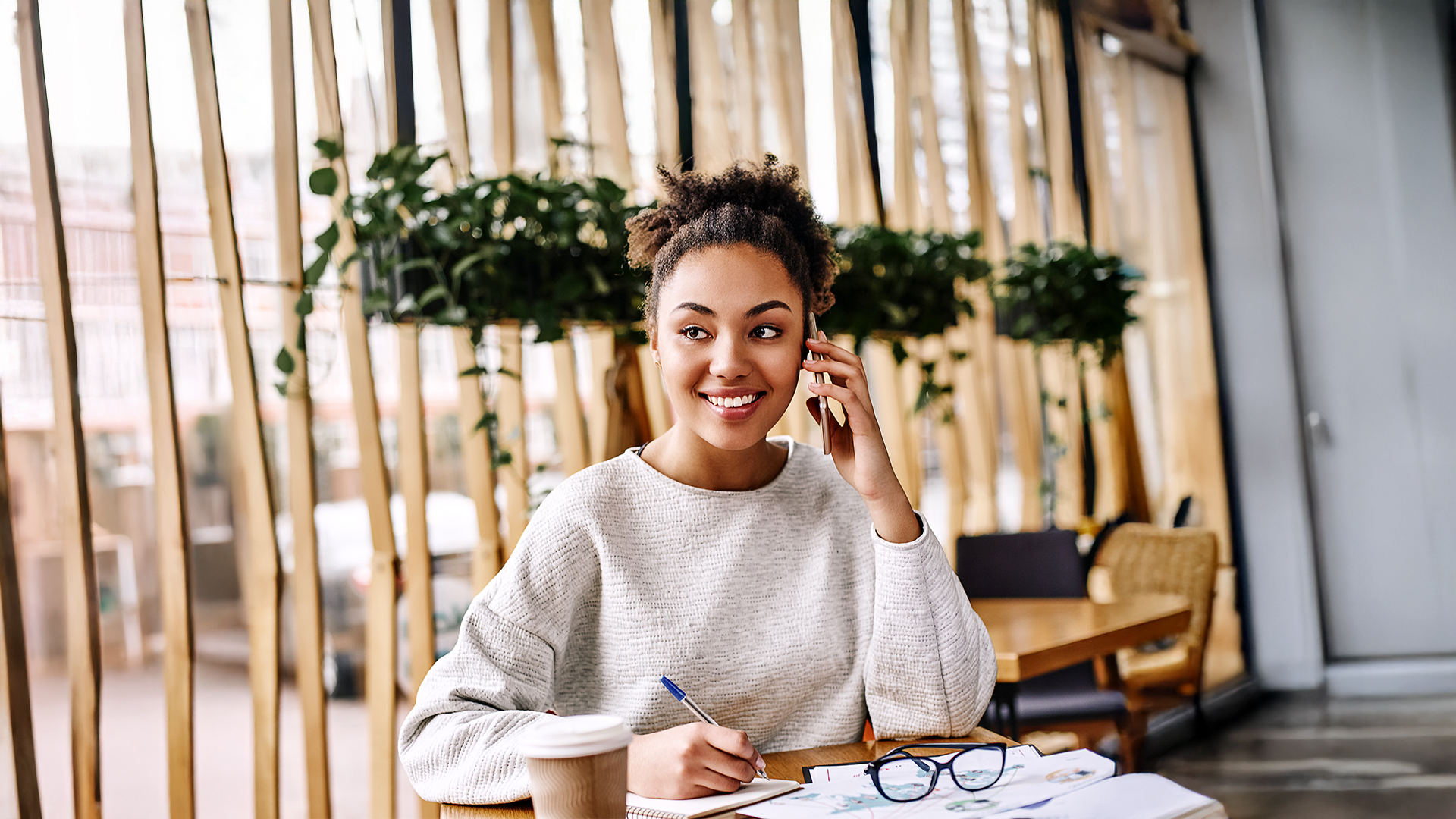 Woman sitting at work desk using her phone